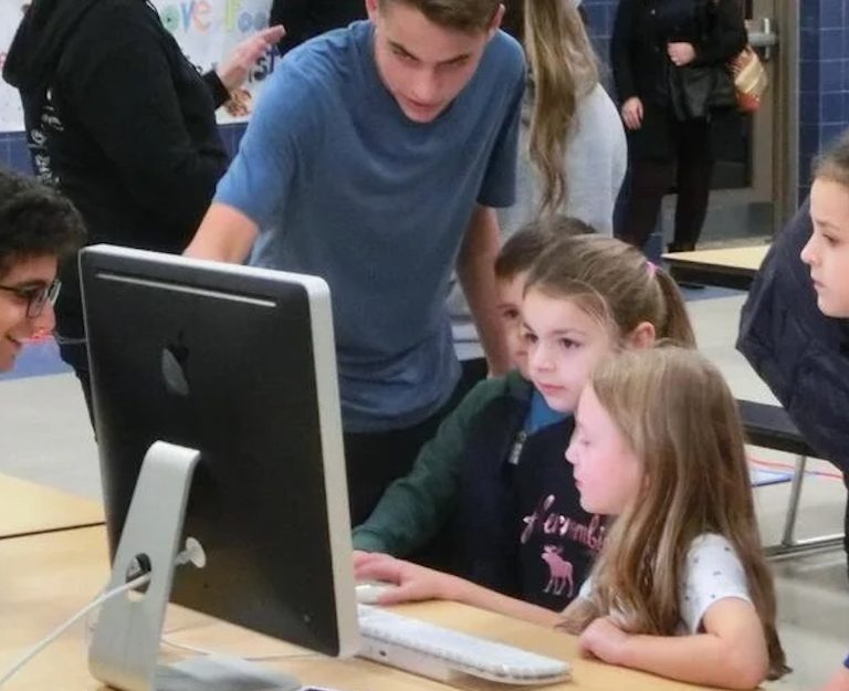 Man showing students something on the display