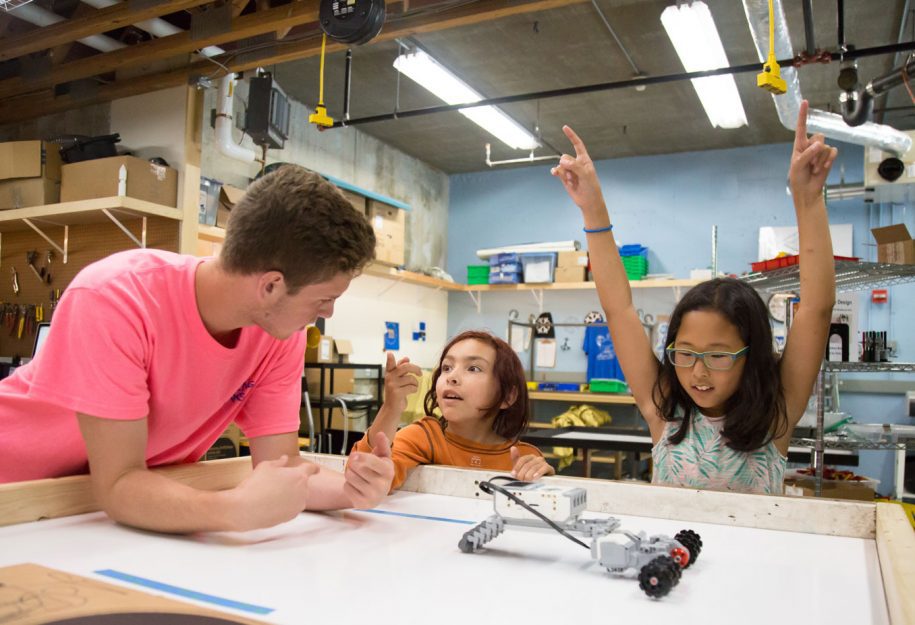 Young kids learning how to make robots.