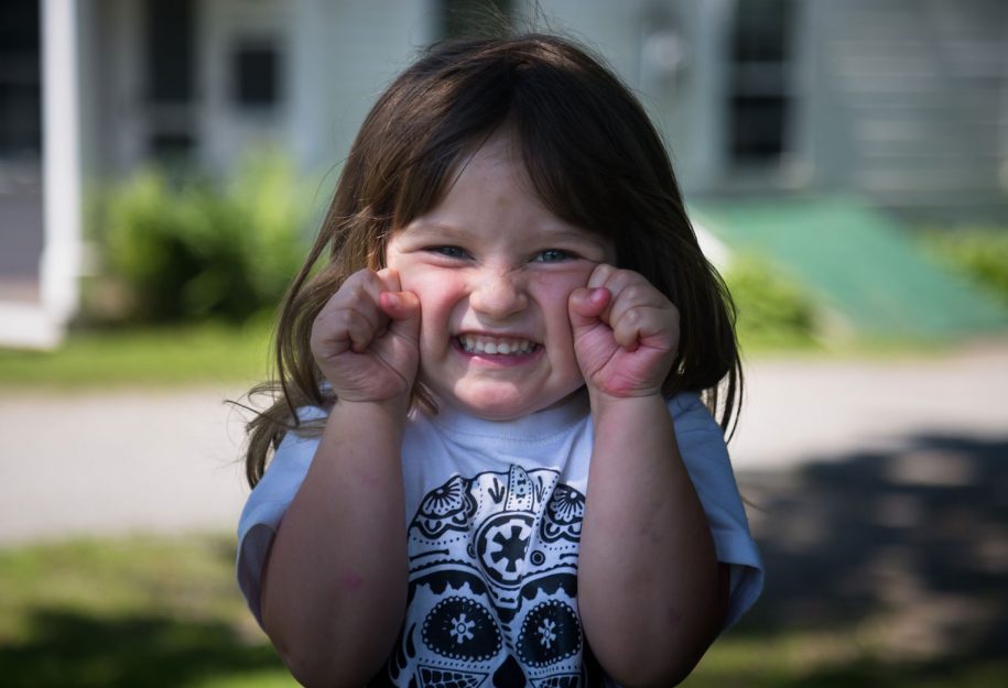 a little girl making a funny face
