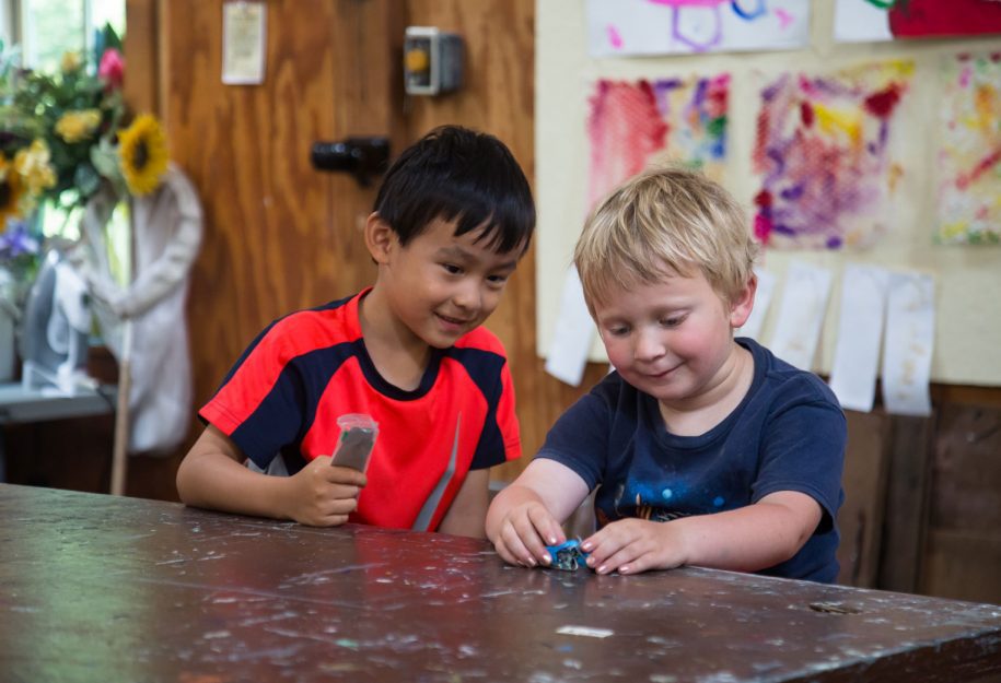 two young boys playing with legos